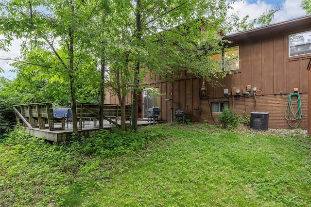 2623 Iris Ave NW, Cedar Rapids, IA 52405 - view of green lawn with a wooden deck and cooling unit