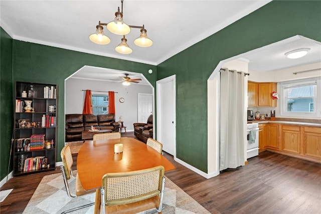 619 I Ave NW, Cedar Rapids, IA 52405 - dining area featuring dark wood-style floors, baseboards, crown molding, and a ceiling fan