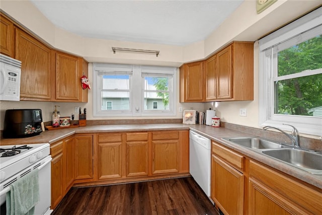 619 I Ave NW, Cedar Rapids, IA 52405 - kitchen featuring white appliances, a sink, dark wood-style floors, light countertops, and brown cabinets