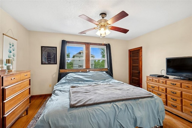 619 I Ave NW, Cedar Rapids, IA 52405 - bedroom featuring wood finished floors, a ceiling fan, and baseboards