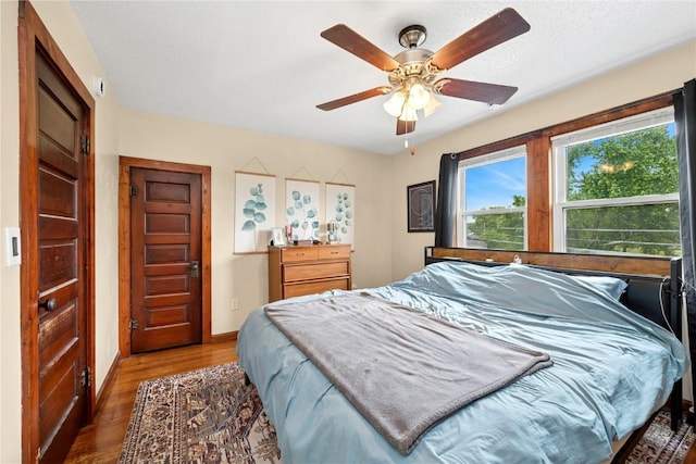619 I Ave NW, Cedar Rapids, IA 52405 - bedroom featuring wood finished floors, baseboards, and ceiling fan