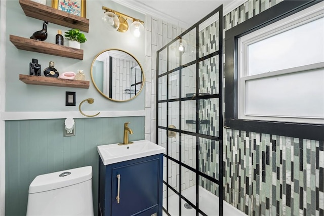 619 I Ave NW, Cedar Rapids, IA 52405 - full bathroom featuring a tile shower, vanity, toilet, and a wainscoted wall