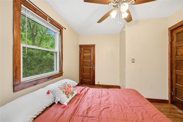 619 I Ave NW, Cedar Rapids, IA 52405 - bedroom with multiple windows, wood finished floors, baseboards, ceiling fan, and vaulted ceiling