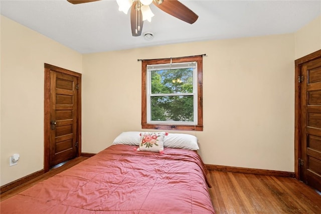 619 I Ave NW, Cedar Rapids, IA 52405 - bedroom featuring baseboards, wood finished floors, and a ceiling fan