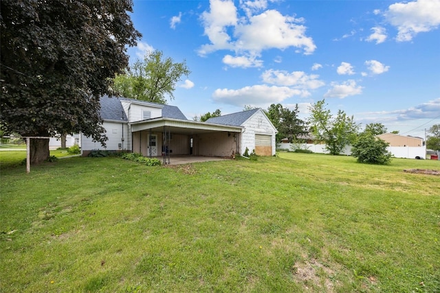 307 2nd Ave, Clarence, IA 52216 - view of grassy yard with a carport and a patio area