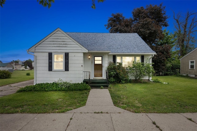 307 2nd Ave, Clarence, IA 52216 - bungalow-style home with a front lawn and a shingled roof