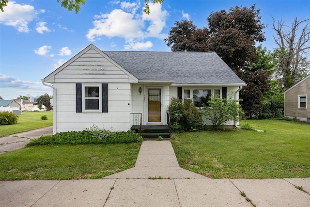 307 2nd Ave, Clarence, IA 52216 - bungalow-style house featuring a front yard and a shingled roof