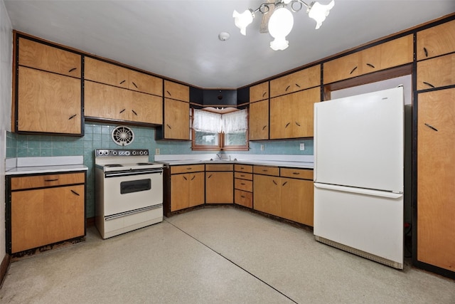 307 2nd Ave, Clarence, IA 52216 - kitchen featuring white appliances, a chandelier, light countertops, a sink, and backsplash