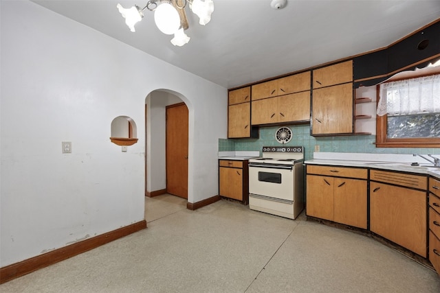 307 2nd Ave, Clarence, IA 52216 - kitchen featuring white range with electric cooktop, a sink, arched walkways, a chandelier, and baseboards