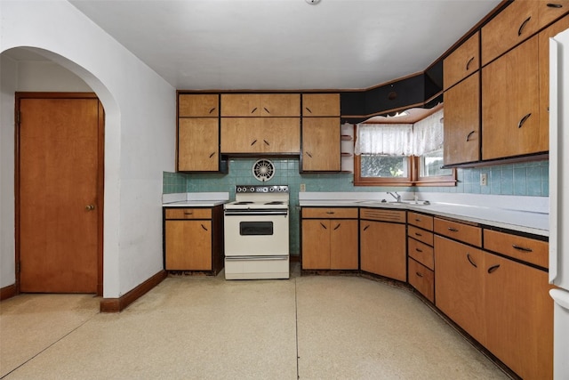 307 2nd Ave, Clarence, IA 52216 - kitchen with electric range, backsplash, light countertops, and a sink