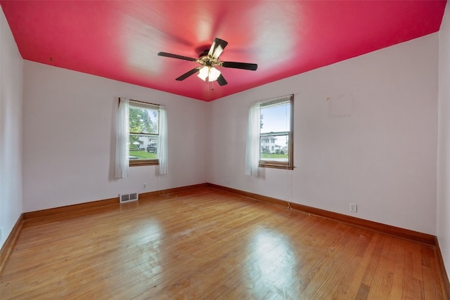 307 2nd Ave, Clarence, IA 52216 - unfurnished room with hardwood / wood-style floors, ceiling fan, and baseboards