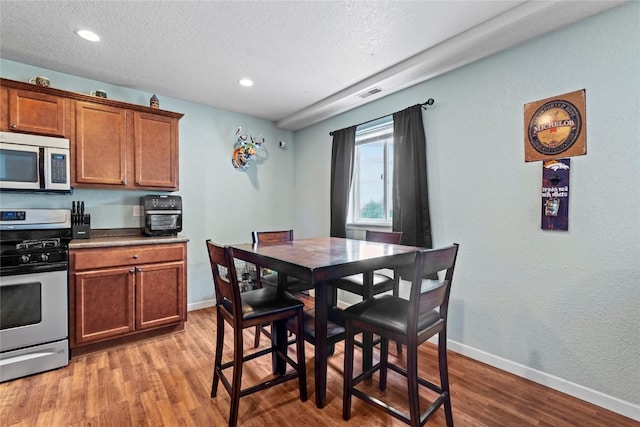 3107 Johnson Ave NW Unit 4, Cedar Rapids, IA 52405 - dining area with light wood-style floors, a textured ceiling, and recessed lighting