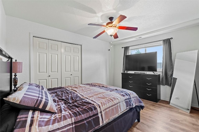 3107 Johnson Ave NW Unit 4, Cedar Rapids, IA 52405 - bedroom with a closet, light wood-type flooring, a ceiling fan, and a textured ceiling