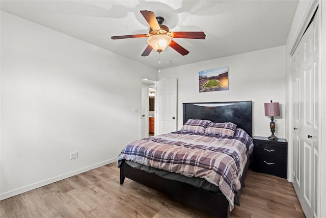 3107 Johnson Ave NW Unit 4, Cedar Rapids, IA 52405 - bedroom featuring a closet, wood finished floors, and a ceiling fan