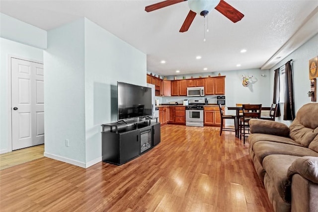 3107 Johnson Ave NW Unit 4, Cedar Rapids, IA 52405 - living room featuring light wood-style flooring, a ceiling fan, and recessed lighting