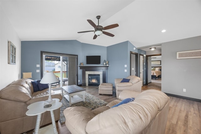 2205 Snapdragon Cir SW, Cedar Rapids, IA 52404 - living area featuring lofted ceiling, wood finished floors, a ceiling fan, a fireplace, and baseboards
