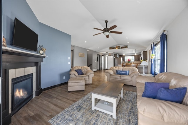 2205 Snapdragon Cir SW, Cedar Rapids, IA 52404 - living area with lofted ceiling, wood finished floors, ceiling fan, a tile fireplace, and baseboards