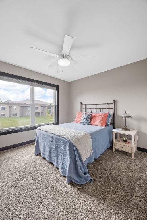 2205 Snapdragon Cir SW, Cedar Rapids, IA 52404 - bedroom with carpet flooring, ceiling fan, and baseboards