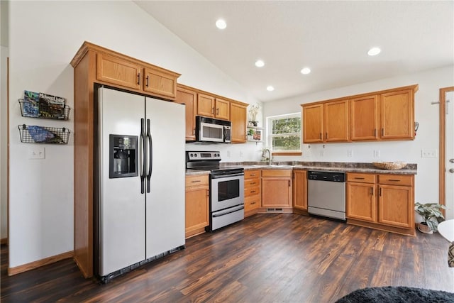 1562 Hunters Creek Way, Marion, IA 52302 - kitchen featuring stainless steel appliances, dark wood finished floors, recessed lighting, lofted ceiling, and brown cabinets