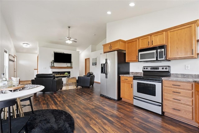 1562 Hunters Creek Way, Marion, IA 52302 - kitchen featuring stainless steel refrigerator with ice dispenser, electric range oven, vaulted ceiling, a lit fireplace, and dark wood finished floors