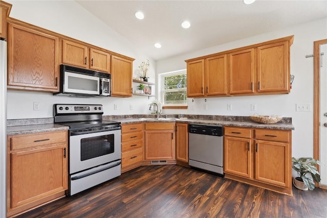 1562 Hunters Creek Way, Marion, IA 52302 - kitchen with appliances with stainless steel finishes, vaulted ceiling, dark wood-type flooring, recessed lighting, and dark countertops