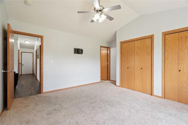 1562 Hunters Creek Way, Marion, IA 52302 - unfurnished bedroom with carpet, two closets, vaulted ceiling, and ceiling fan