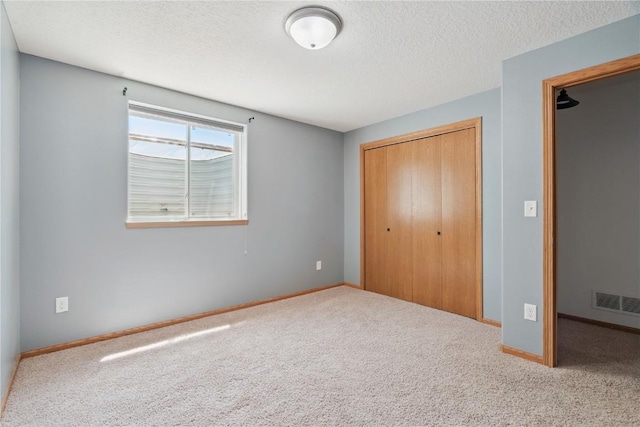 1562 Hunters Creek Way, Marion, IA 52302 - unfurnished bedroom with a closet, a textured ceiling, and carpet flooring