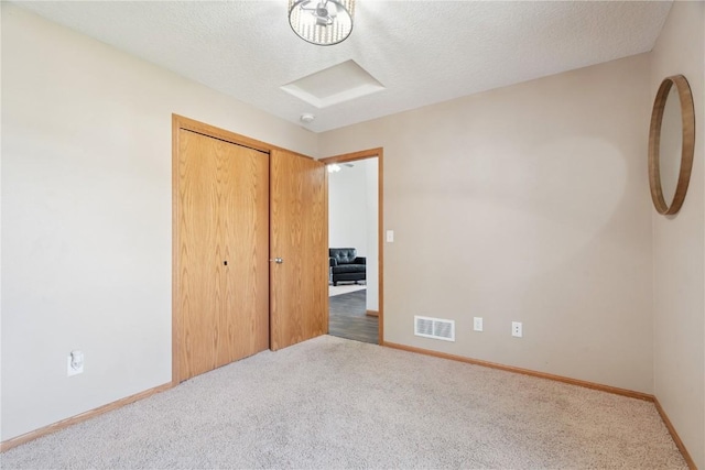 1562 Hunters Creek Way, Marion, IA 52302 - unfurnished bedroom featuring carpet floors, a textured ceiling, and a closet