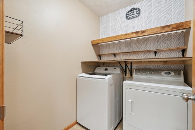 1562 Hunters Creek Way, Marion, IA 52302 - washroom featuring washer and clothes dryer, a textured ceiling, and wallpapered walls