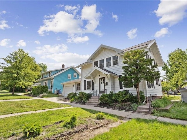 1813 3rd Ave SE, Cedar Rapids, IA 52403 - view of front of home featuring an attached garage and a front lawn
