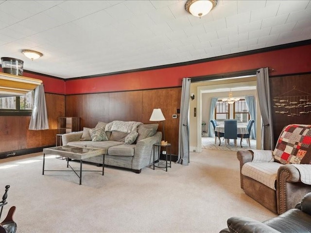 1813 3rd Ave SE, Cedar Rapids, IA 52403 - living area featuring healthy amount of natural light, carpet flooring, a chandelier, wooden walls, and crown molding