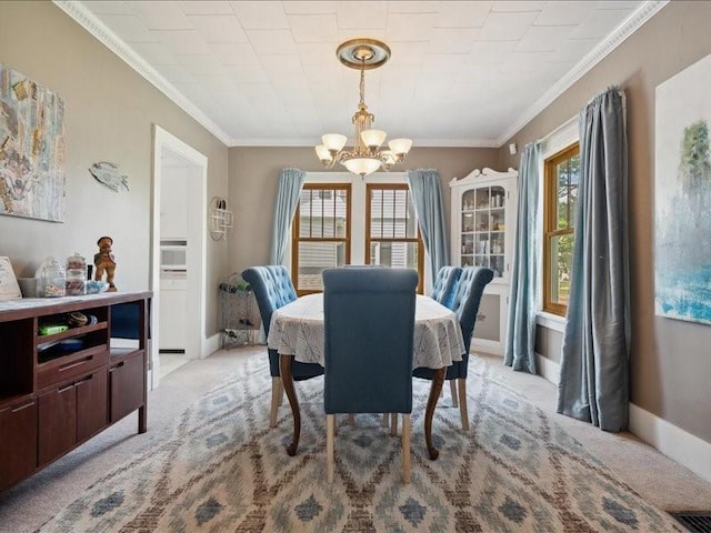 1813 3rd Ave SE, Cedar Rapids, IA 52403 - dining room featuring a chandelier, crown molding, light carpet, and baseboards