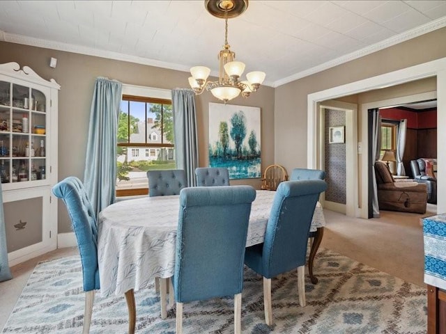 1813 3rd Ave SE, Cedar Rapids, IA 52403 - dining space featuring a chandelier, crown molding, and light carpet