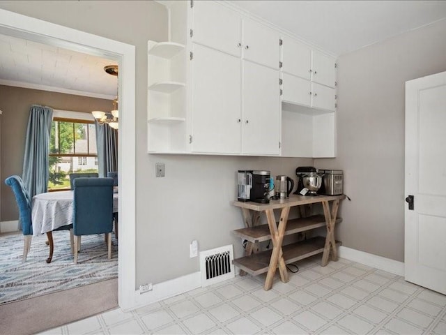 1813 3rd Ave SE, Cedar Rapids, IA 52403 - kitchen with a chandelier, baseboards, white cabinetry, open shelves, and light flooring