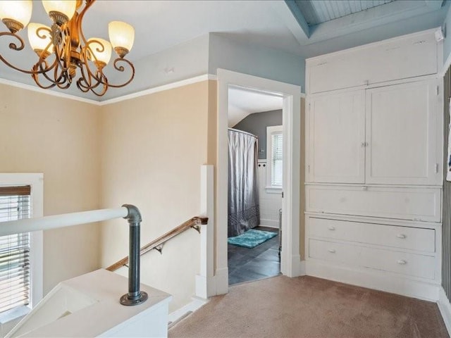 1813 3rd Ave SE, Cedar Rapids, IA 52403 - hall featuring an upstairs landing, a chandelier, light colored carpet, and baseboards