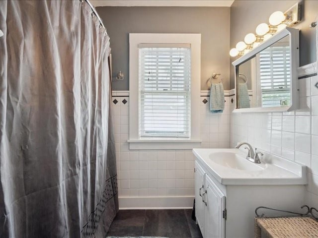 1813 3rd Ave SE, Cedar Rapids, IA 52403 - bathroom featuring tile walls, vanity, tile patterned flooring, and wainscoting