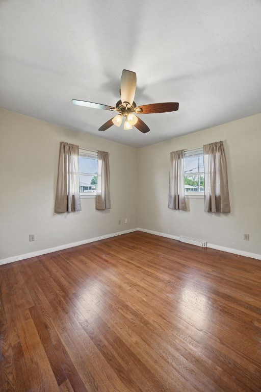 2705 14th Ave, Marion, IA 52302 - unfurnished room with plenty of natural light, ceiling fan, and wood finished floors
