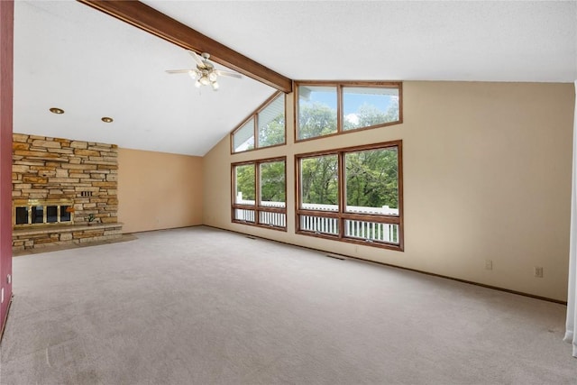 340 Country Club Dr SE, Mount Vernon, IA 52314 - unfurnished living room featuring carpet flooring, a ceiling fan, a stone fireplace, and baseboards