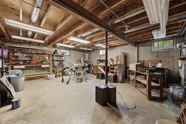 1724 Hamer Dr NW, Cedar Rapids, IA 52405 - basement featuring a workshop area, brick wall, and electric panel