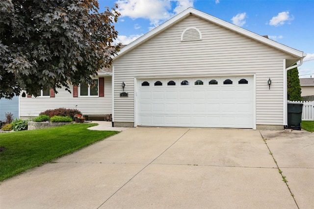 1724 Hamer Dr NW, Cedar Rapids, IA 52405 - view of front of house featuring a front lawn, concrete driveway, and an attached garage