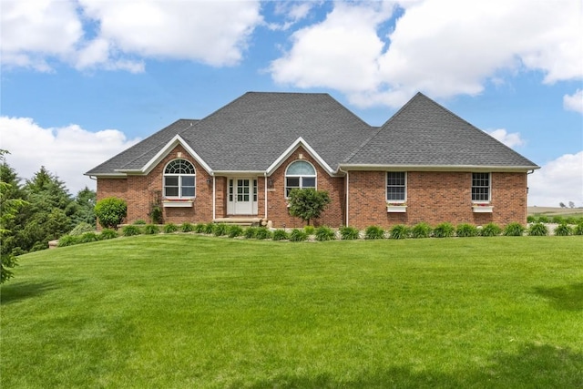 1355 Red Star Rd, Tipton, IA 52772 - view of front facade featuring a front yard, a shingled roof, and brick siding