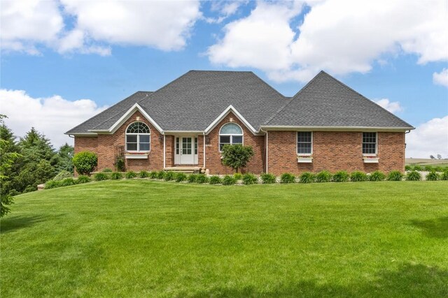 1355 Red Star Rd, Tipton, IA 52772 - view of front of house featuring a front yard, roof with shingles, and brick siding