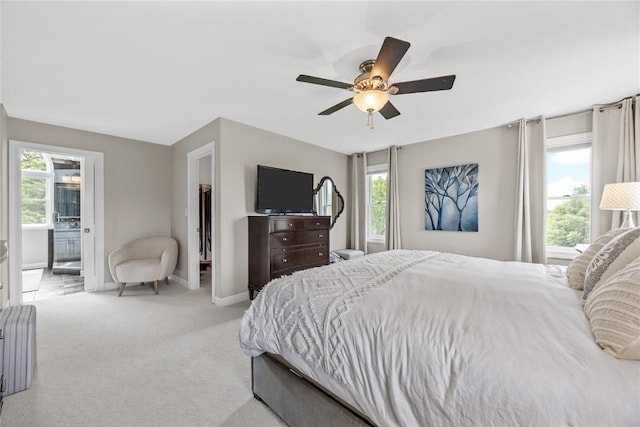 1355 Red Star Rd, Tipton, IA 52772 - carpeted bedroom featuring multiple windows, baseboards, a ceiling fan, and connected bathroom