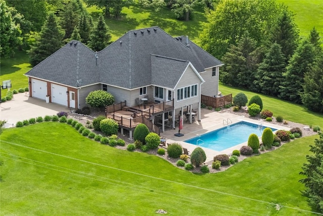 1355 Red Star Rd, Tipton, IA 52772 - rear view of property with a wooden deck, a yard, a garage, stairs, and a shingled roof