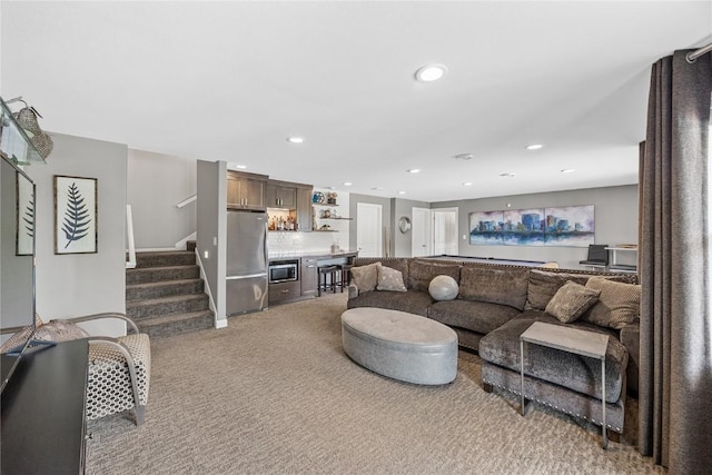 1355 Red Star Rd, Tipton, IA 52772 - carpeted living room with bar area, recessed lighting, and stairway