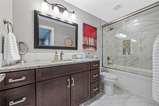1355 Red Star Rd, Tipton, IA 52772 - bathroom with marble finish flooring, vanity, bath / shower combo with glass door, and toilet
