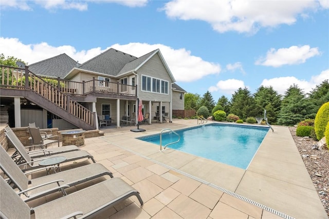 1355 Red Star Rd, Tipton, IA 52772 - swimming pool featuring stairway, a wooden deck, a patio, and a fire pit