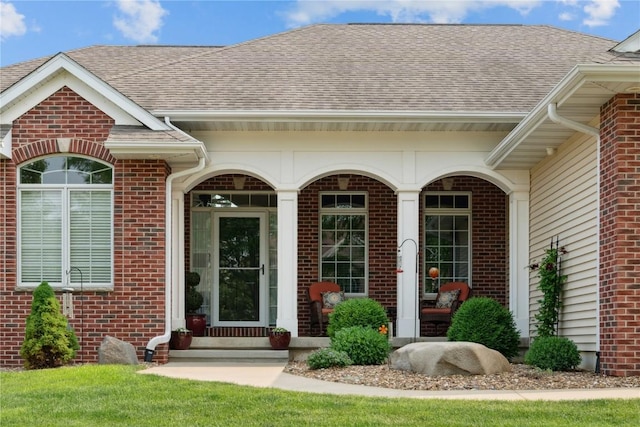 1485 Huntington Hills Dr, Marion, IA 52302 - entrance to property with brick siding, covered porch, and roof with shingles