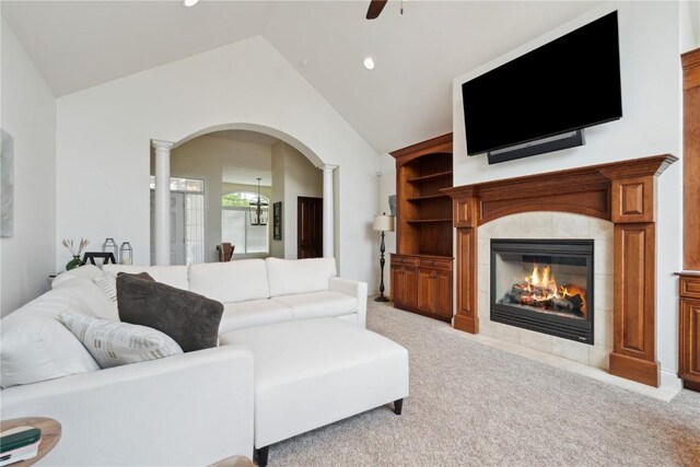 1485 Huntington Hills Dr, Marion, IA 52302 - living area with arched walkways, ceiling fan, lofted ceiling, a fireplace, and light carpet