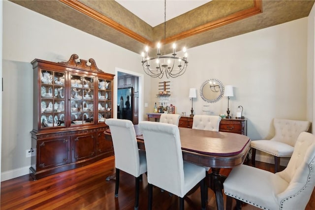 1485 Huntington Hills Dr, Marion, IA 52302 - dining area with a raised ceiling, dark wood-type flooring, a chandelier, and baseboards